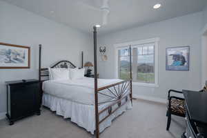 Bedroom with light carpet, a ceiling fan, and recessed lighting