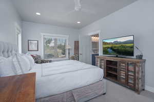 Carpeted bedroom with recessed lighting and ceiling fan