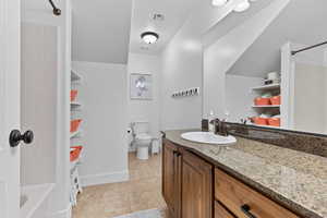 Bathroom featuring vanity, tub / shower combination, and tile patterned floors