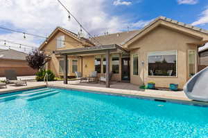 Swimming pool featuring a patio area and a water slide
