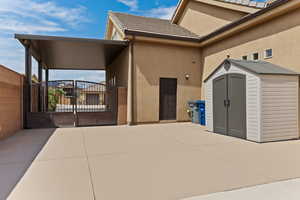 View of exterior entry with a gate and stucco siding