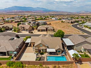 Aerial view of residential area with a mountainous background and a pool area