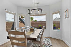 Dining room with plenty of natural light and light wood-style flooring