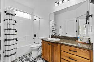 Bathroom with vanity and shower / bath combo with shower curtain