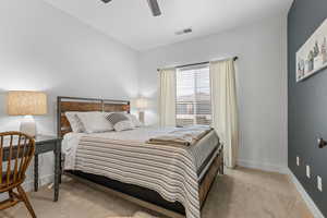 Bedroom featuring light colored carpet and ceiling fan