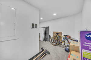 Workout room with carpet flooring and recessed lighting