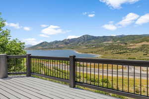 Deck with a water and mountain view