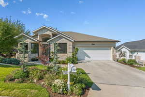 Single story home featuring concrete driveway and an attached garage