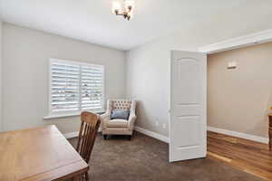 Office area featuring wood finished floors and a chandelier