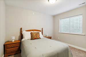 Carpeted bedroom featuring baseboards