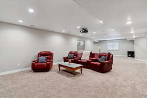 Living area featuring carpet floors and recessed lighting