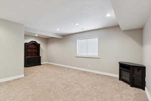 Below grade area featuring carpet floors and recessed lighting