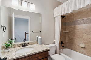 Bathroom with vanity and shower / bath combination with curtain