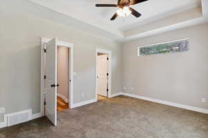 Unfurnished bedroom featuring carpet and a ceiling fan