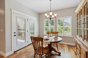 Dining room with a chandelier and light wood-type flooring