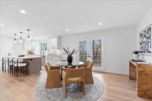 Dining area featuring light wood-type flooring, french doors, and recessed lighting