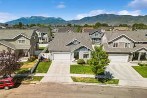 View of property with driveway, a residential view, and a mountain view