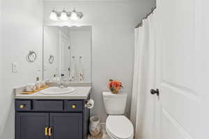 Full bath featuring vanity and toilet