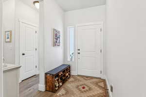Entrance foyer featuring light wood-style floors and baseboards