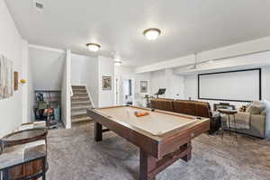 Playroom with carpet, pool table, and a textured ceiling