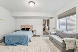 Bedroom featuring carpet floors and baseboards