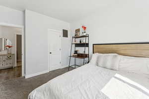Bedroom featuring carpet and baseboards