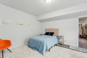 Carpeted bedroom featuring baseboards