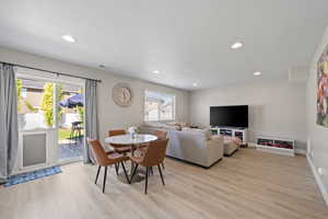 Dining space with light wood-type flooring and recessed lighting