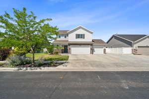 View of front of home with driveway and a garage