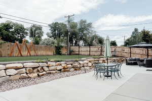 Fenced backyard with outdoor lounge area, a patio area, and outdoor dining area
