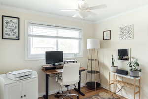 Office area with wood floors, ceiling fan, and ornamental molding