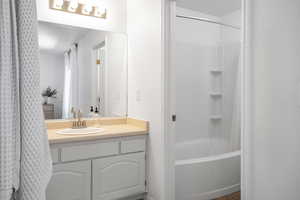 Full bathroom with vanity and shower / bathtub combination with curtain