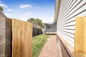 Fenced backyard with a trampoline