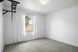 Unfurnished room featuring carpet floors and baseboards