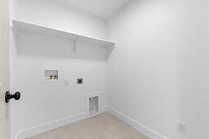 Laundry room featuring electric dryer hookup and washer hookup