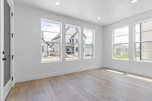 Unfurnished room with light wood finished floors and recessed lighting