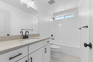 Full bath with vanity, shower / washtub combination, and tile patterned flooring