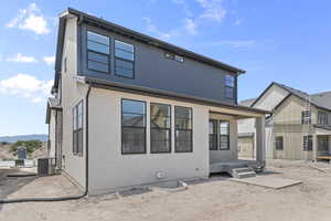 Back of house with stucco siding and a mountain view