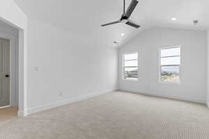 Unfurnished room featuring light carpet, a ceiling fan, lofted ceiling, and recessed lighting