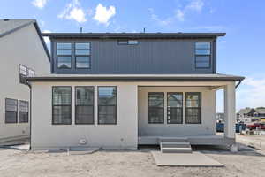 Back of property featuring a porch, a metal roof, and a standing seam roof