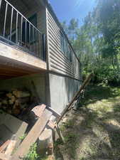 View of side of home featuring faux log siding