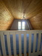 Bonus room featuring wood ceiling, vaulted ceiling, and ceiling fan