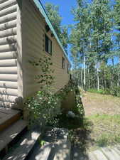 View of side of property featuring faux log siding
