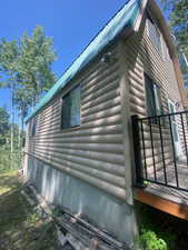 View of home's exterior with faux log siding