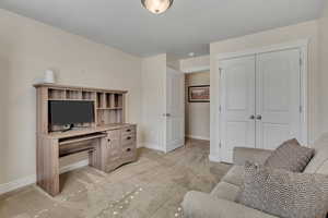 Office space featuring light colored carpet and baseboards