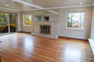 Lliving room with a high end fireplace, and recessed lighting