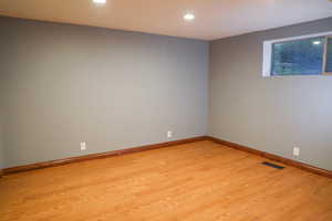 Bedroom with light wood-style flooring and recessed lighting