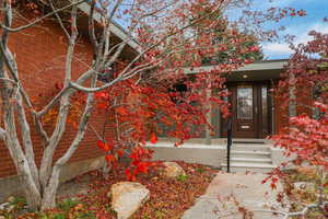Property entrance featuring brick siding