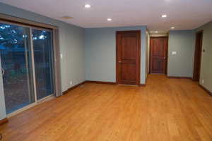 Family room with walk out basement, recessed lighting and light wood-style floors