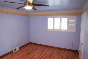 Bedroom with hardwood finished floors and a ceiling fan